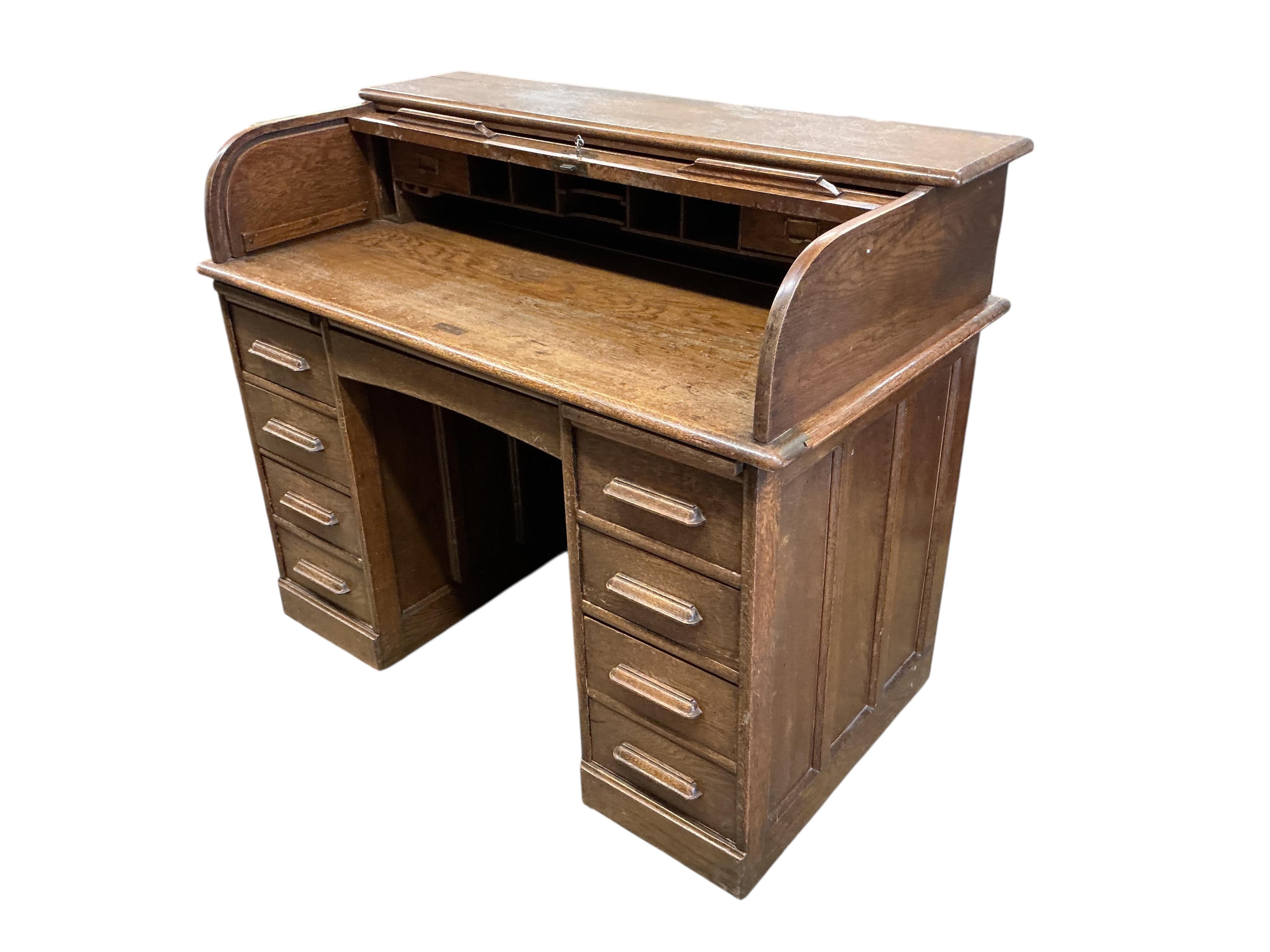 An early 20th century oak roll top desk, width 122cm, depth 66cm, height 101cm